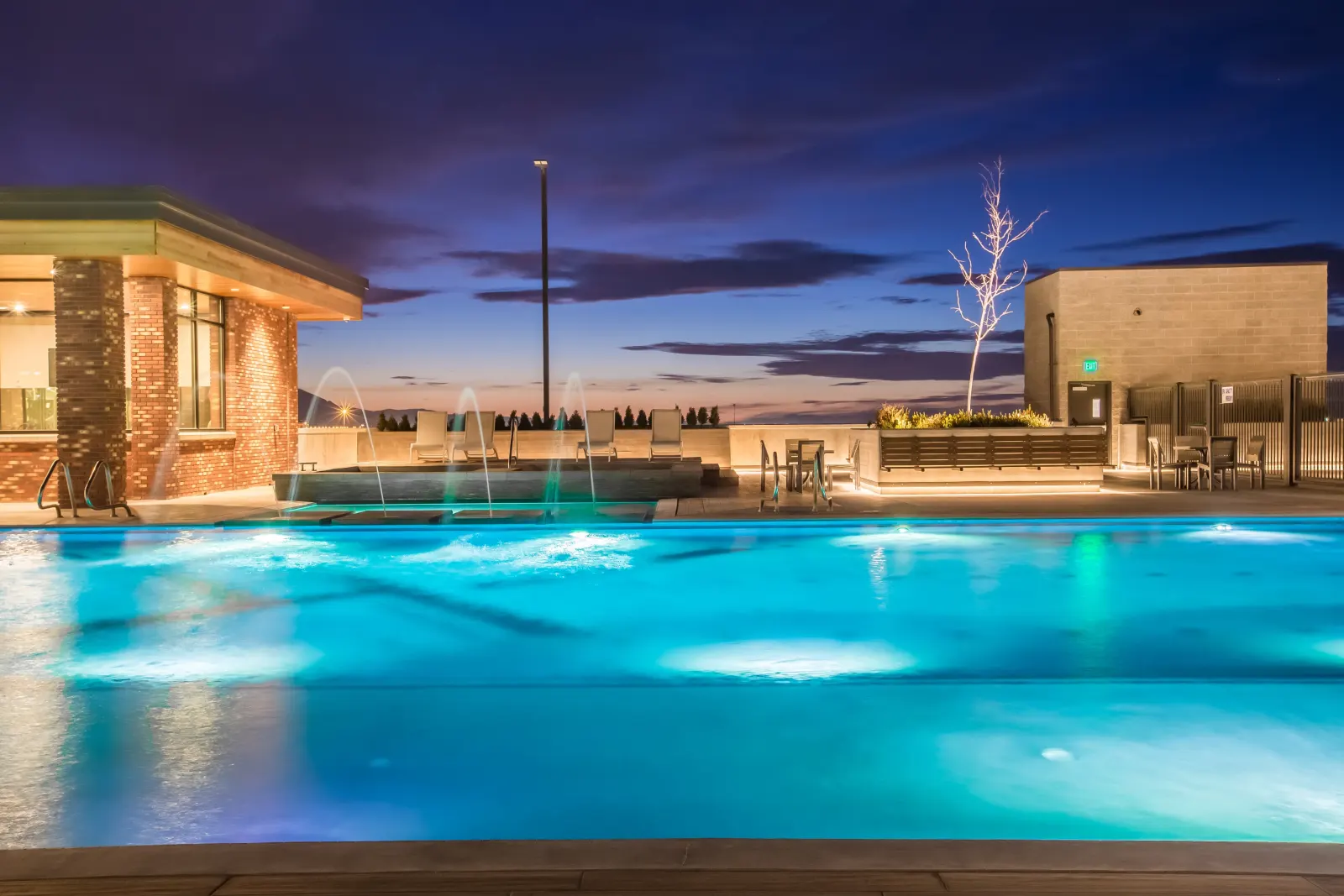4th West rooftop pool aerial — Salt Lake City skyline beyond. Photo by Lindsay Salazar.