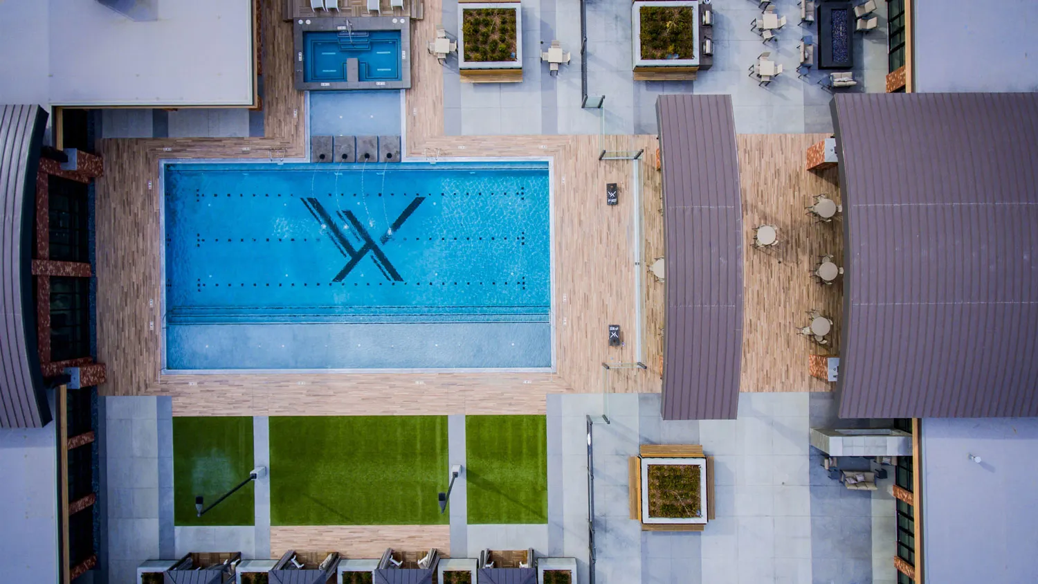 STAND-IN BRANDON TO VET — full rooftop aerial showing the deck, Olympic pool, and surrounding courtyards
