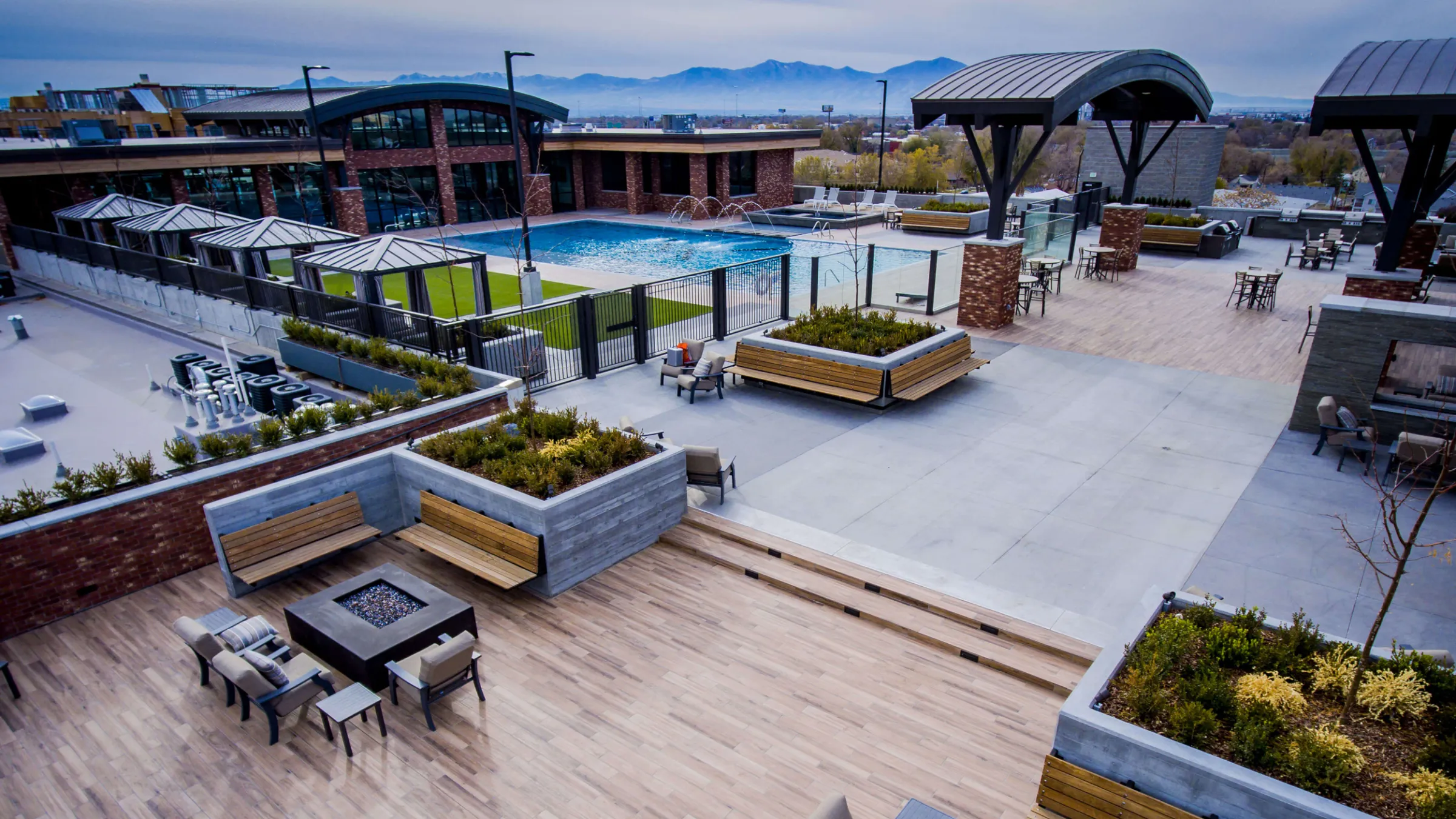 The rooftop deck, cabanas and pool with the city beyond